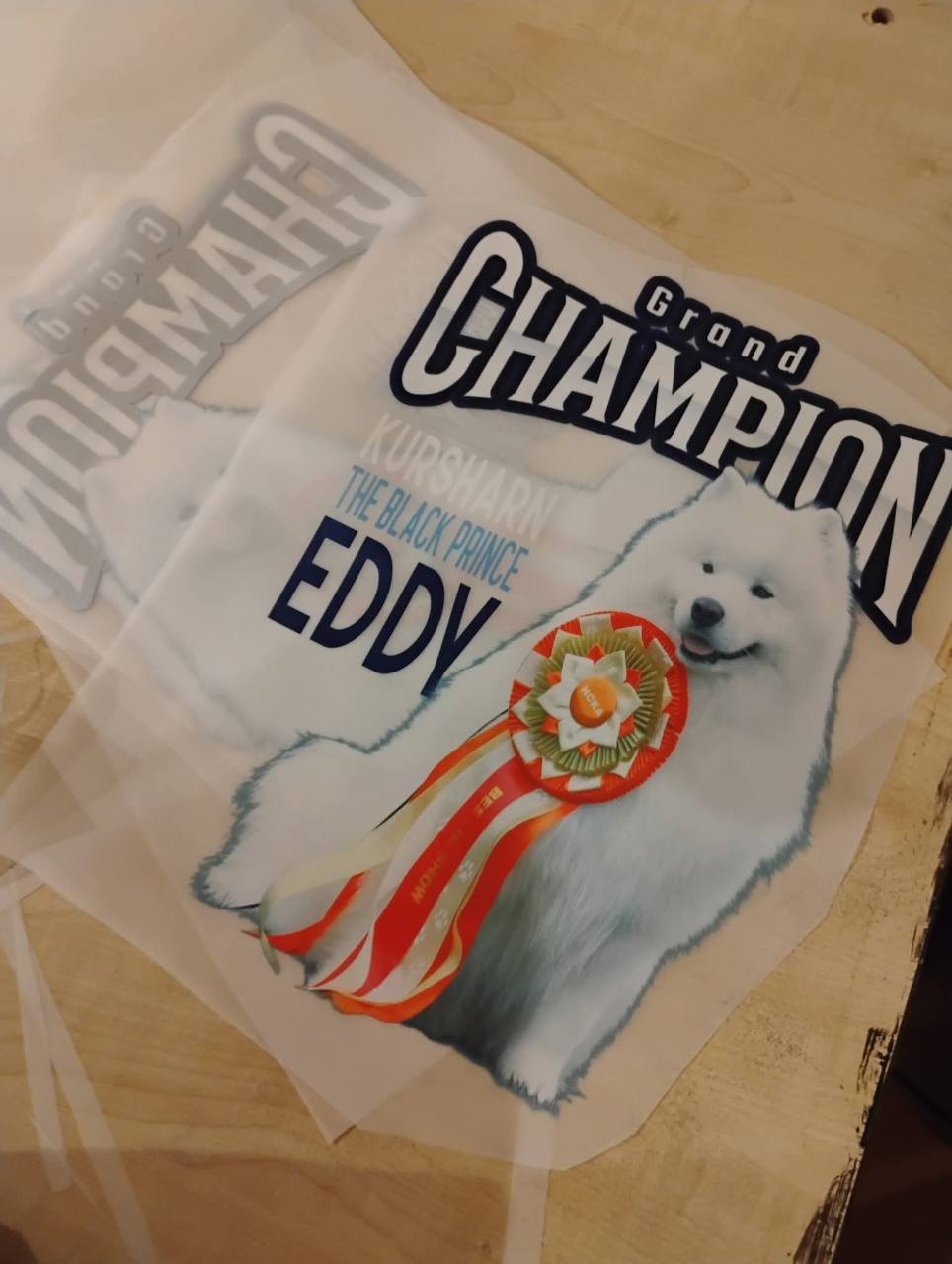 Grand Champion Eddy print transfers featuring a white dog wearing an award ribbon.