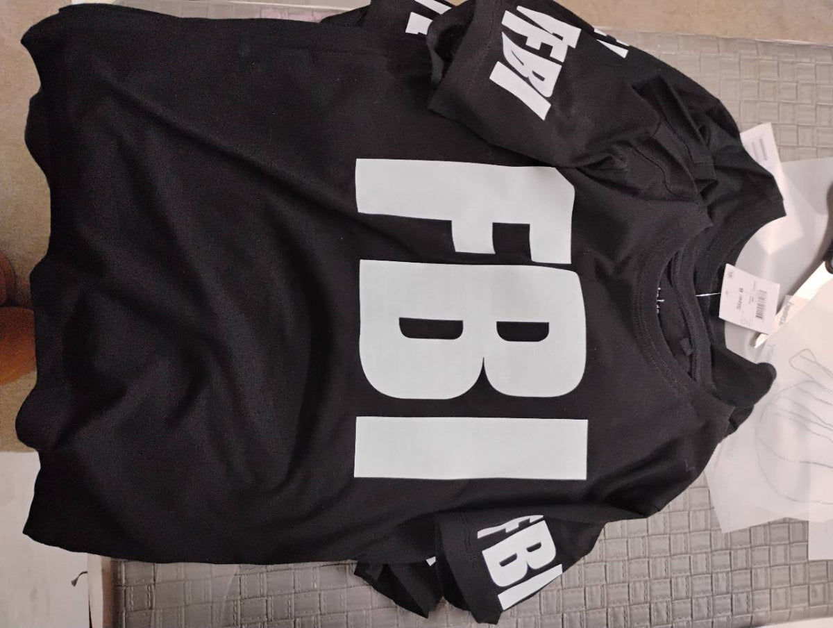 Black T-shirt with large white FBI lettering across the front and matching sleeve prints.
