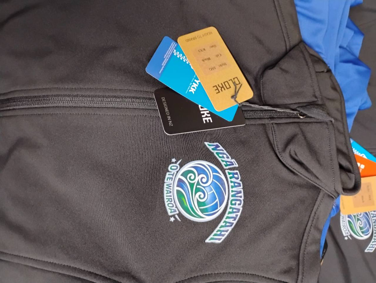 Charcoal zip jacket with a blue, green and white Ngā Rangatahi O Te Wairoa chest logo.
